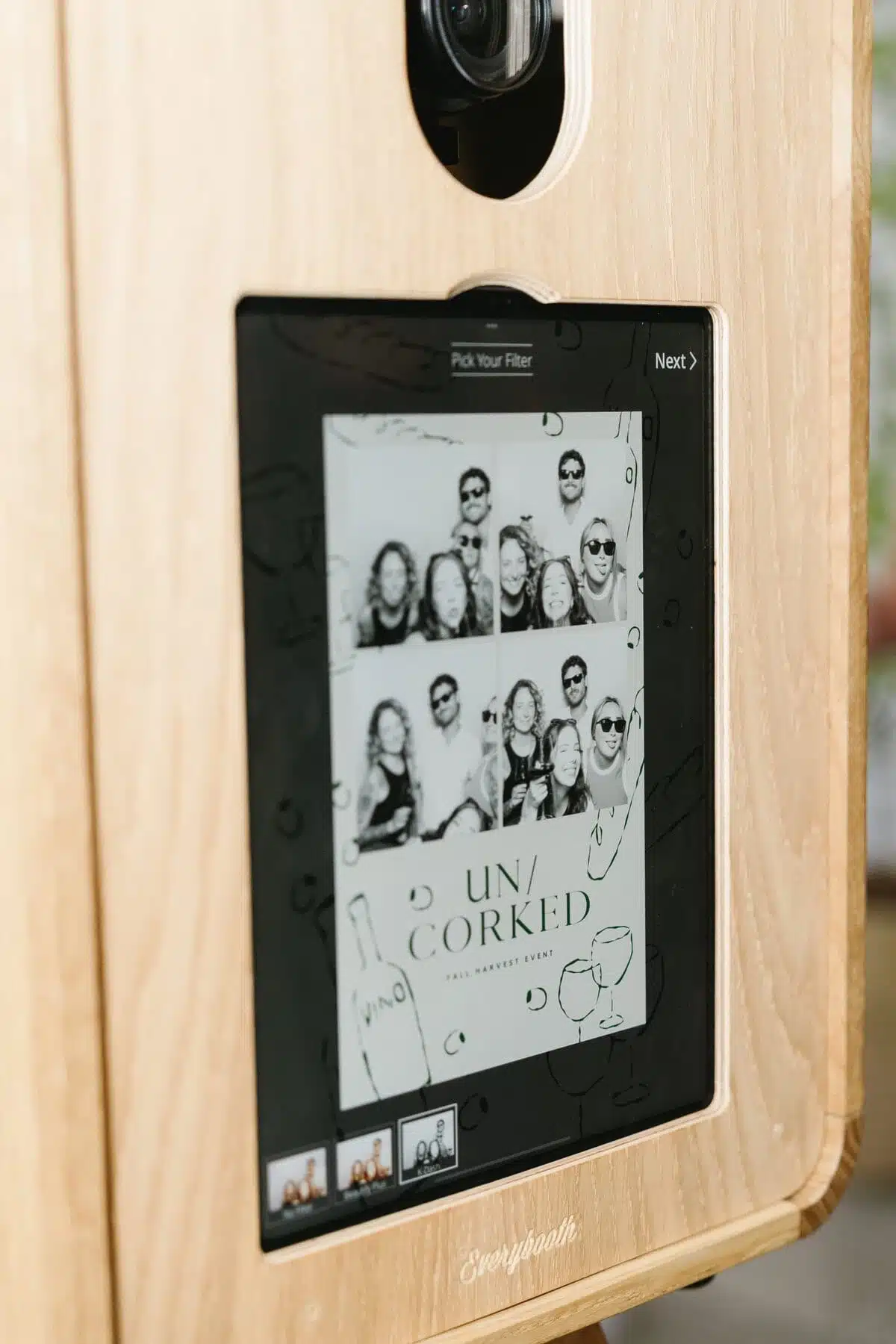 Close-up of the MooMuu ICON Booth screen showing branded black-and-white portraits.