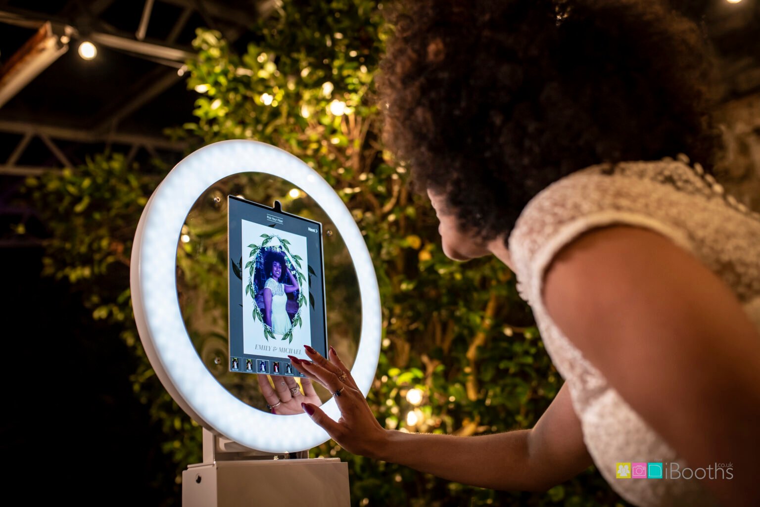 Guest using the touchscreen and ring light on the MooMuu Digital Booth.