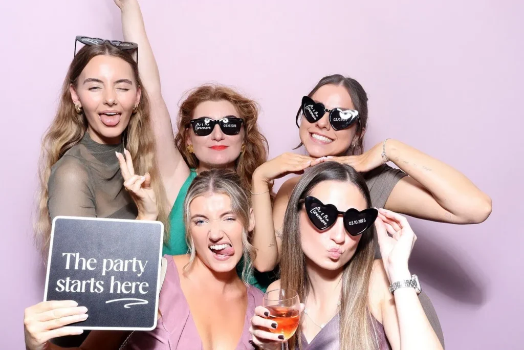 guests standing in front of a pink backdrop