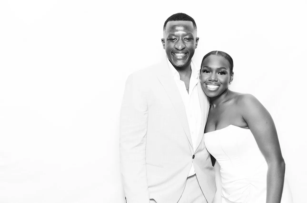 black and white glam photo of a bride and groom looking at the camera