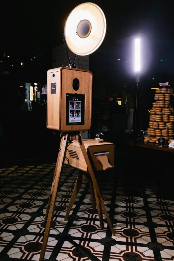 MooMuu ICON Booth with its circular studio light and print unit beside a doughnut table.