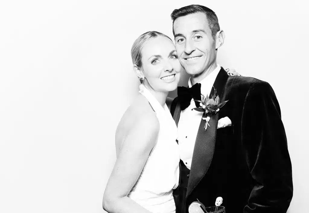 Wedding couple posing against a clean white backdrop for the Signature Glam Booth.