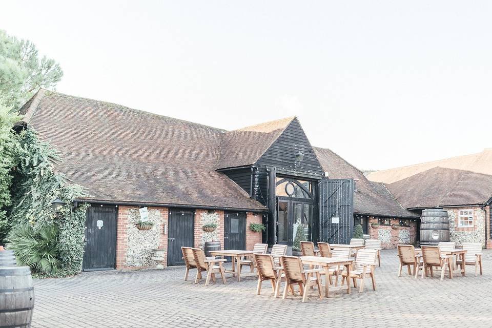 The courtyard and rustic barn buildings at Old Luxters Barn