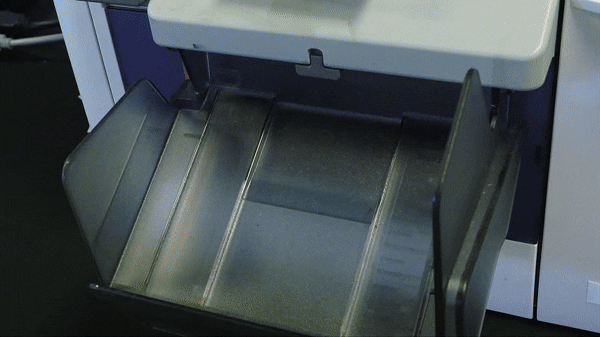 A close-up of a printer ejecting a freshly printed sheet, capturing the precision and detail perfect for the Mosaic Wall hire