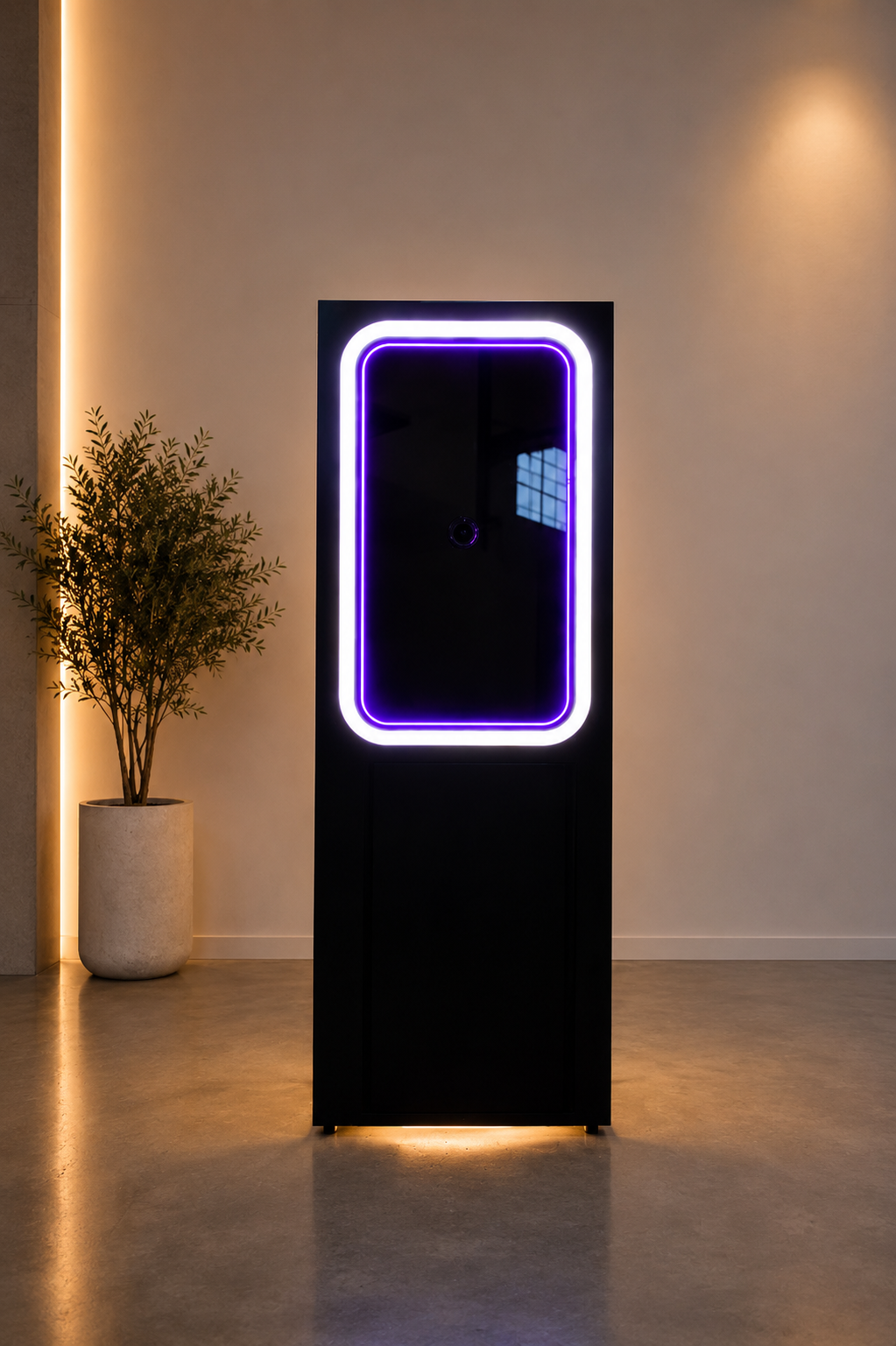 Front view of the illuminated black Scribble Booth in a modern setting