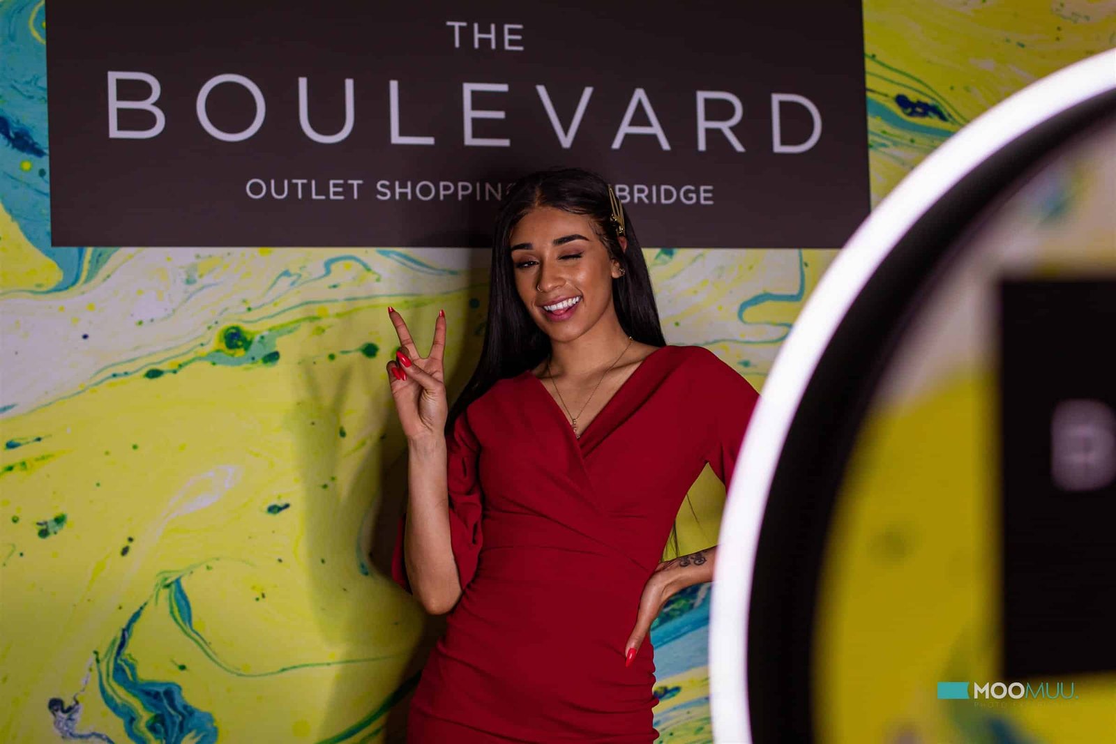 Guest posing at a branded MooMuu corporate photo booth activation.