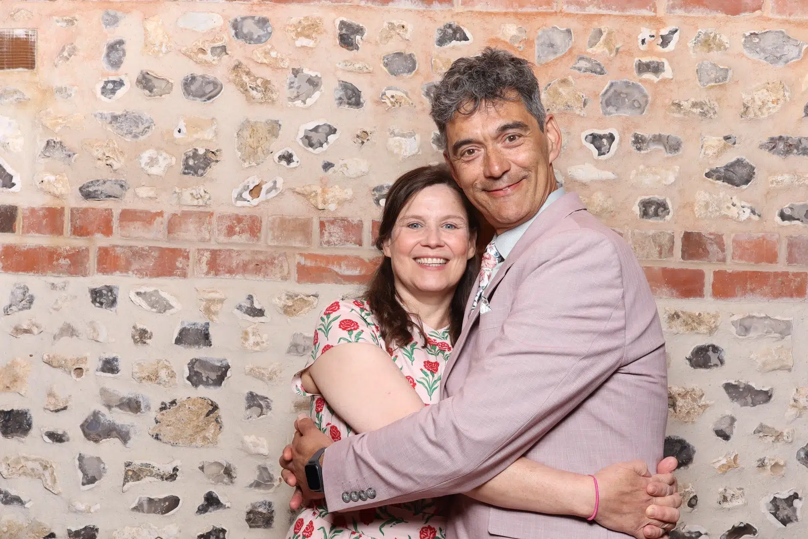 Two wedding guests smiling in a MooMuu colour portrait at The Gathering Barn