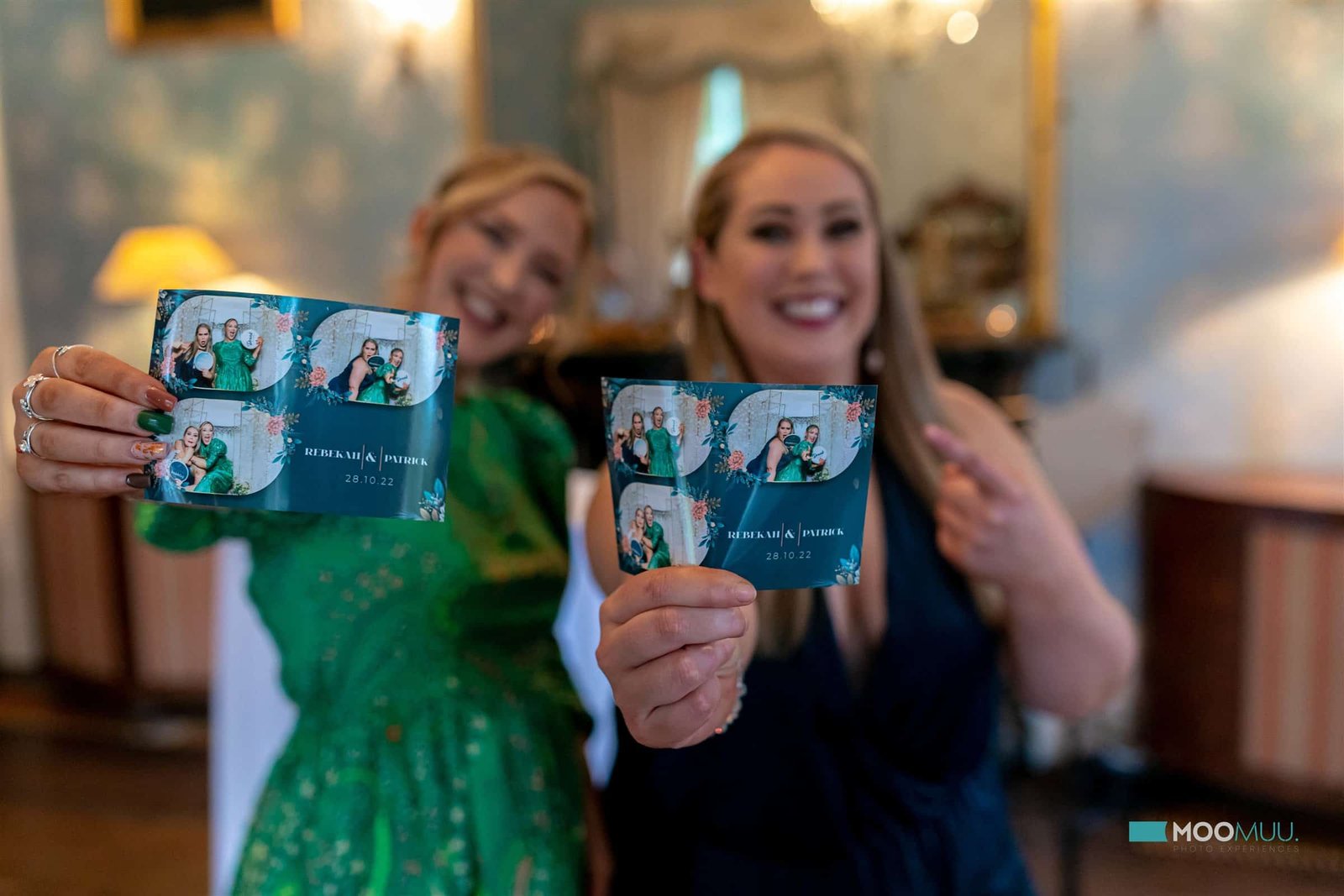 Guests showing their personalised MooMuu photo booth prints.