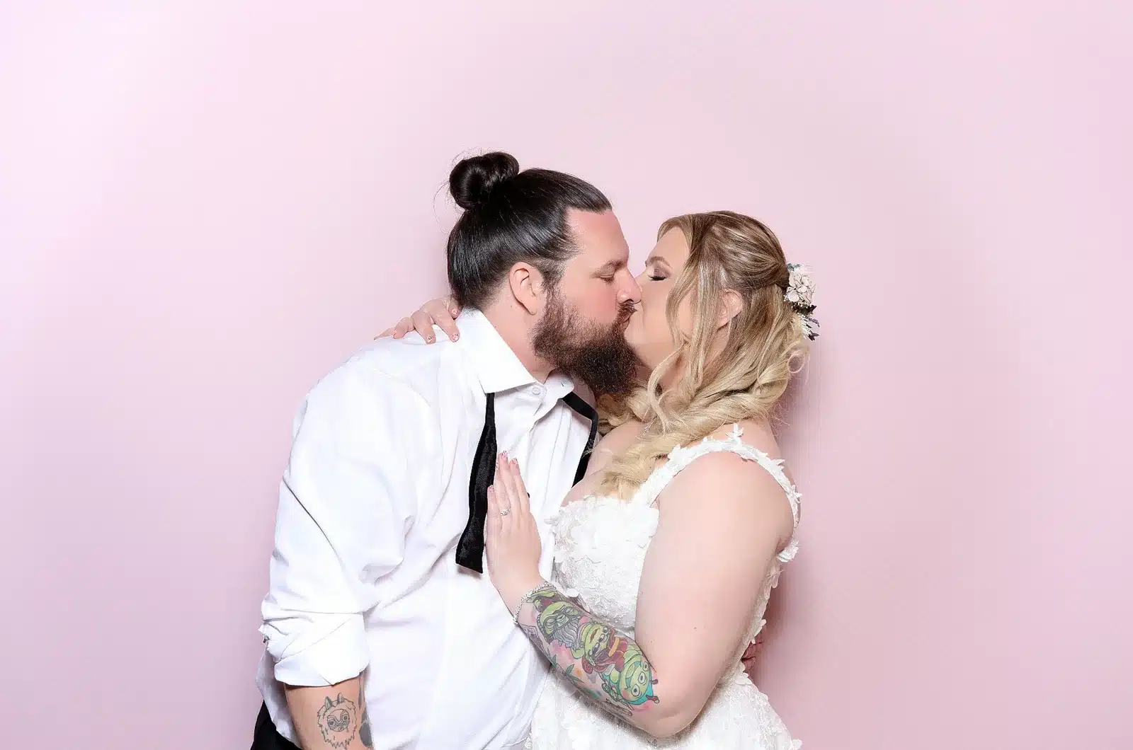 Newlyweds sharing a portrait captured with the MooMuu ICON Booth