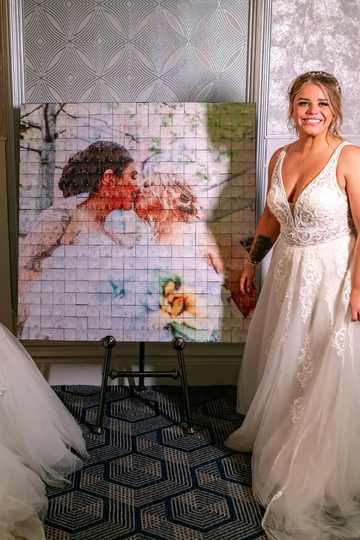 Bride beside a completed personalised wedding photo Mosaic Wall.