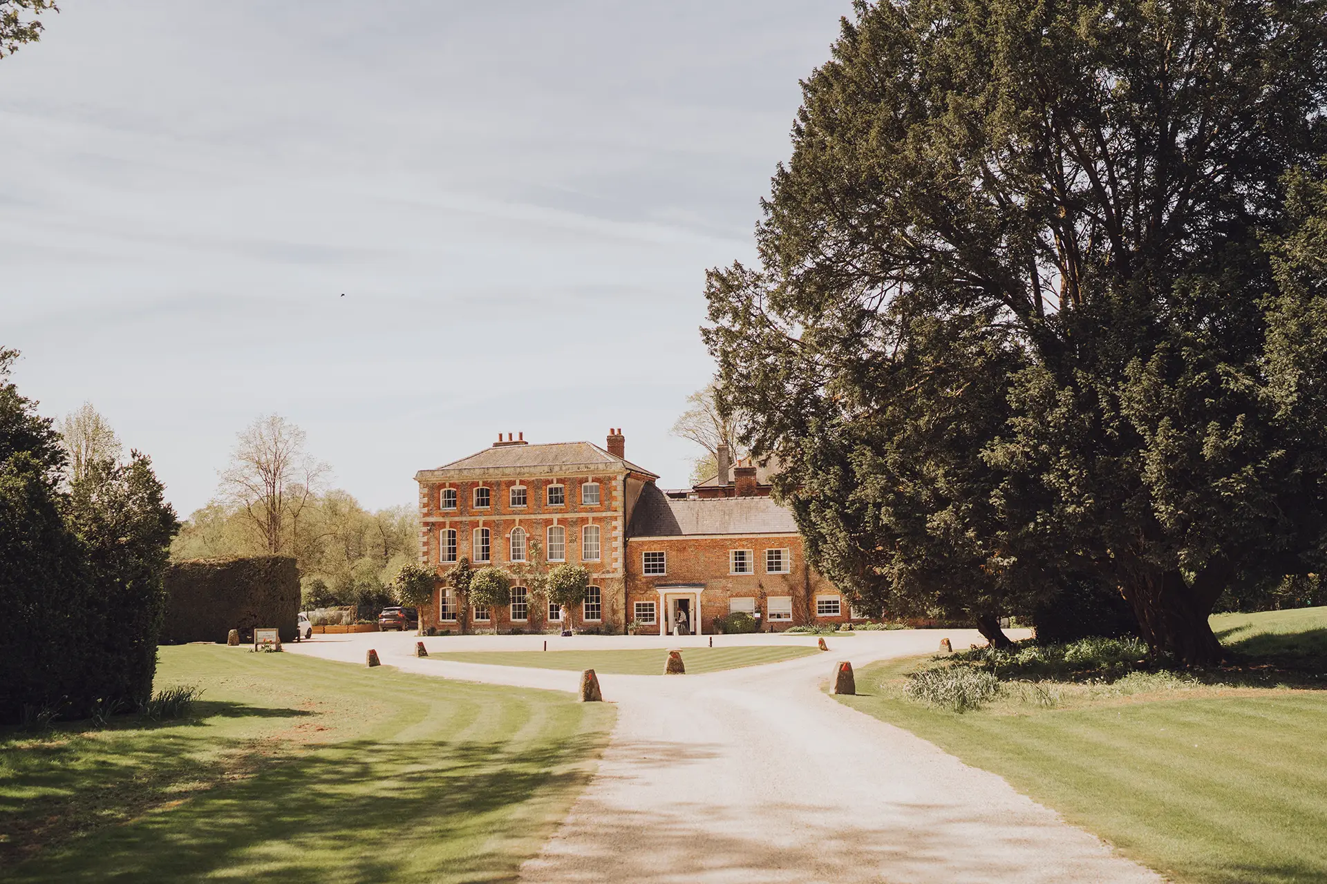 Syrencot manor house and landscaped grounds viewed from the entrance drive