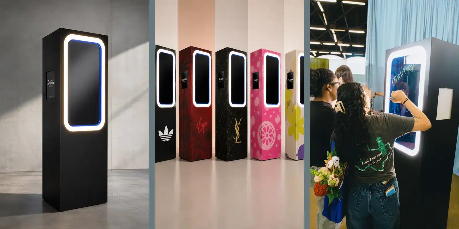 Scribble Booth shown in its premium black finish, with bespoke event branding and guests writing on the interactive glass