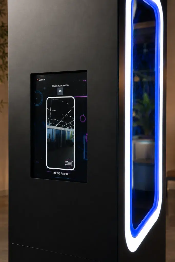 Close-up of the Scribble Booth touchscreen beside the illuminated glass